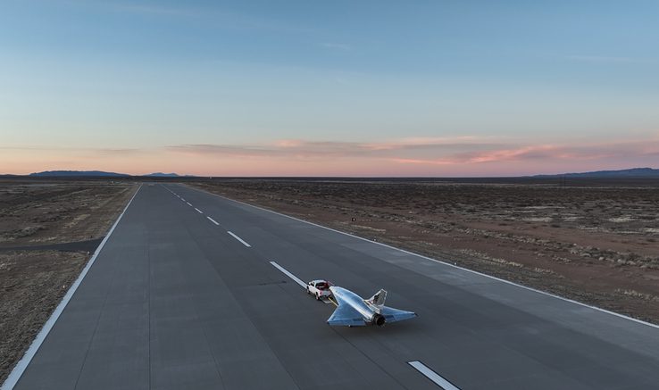 A sleek aircraft on a deserted runway at sunset, showcasing advanced aerospace technology and innovation.