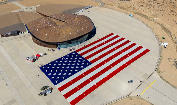 Aerial view of Spaceport America, showcasing its integration into the New Mexico desert landscape with the Great American Flag Preservation Group.